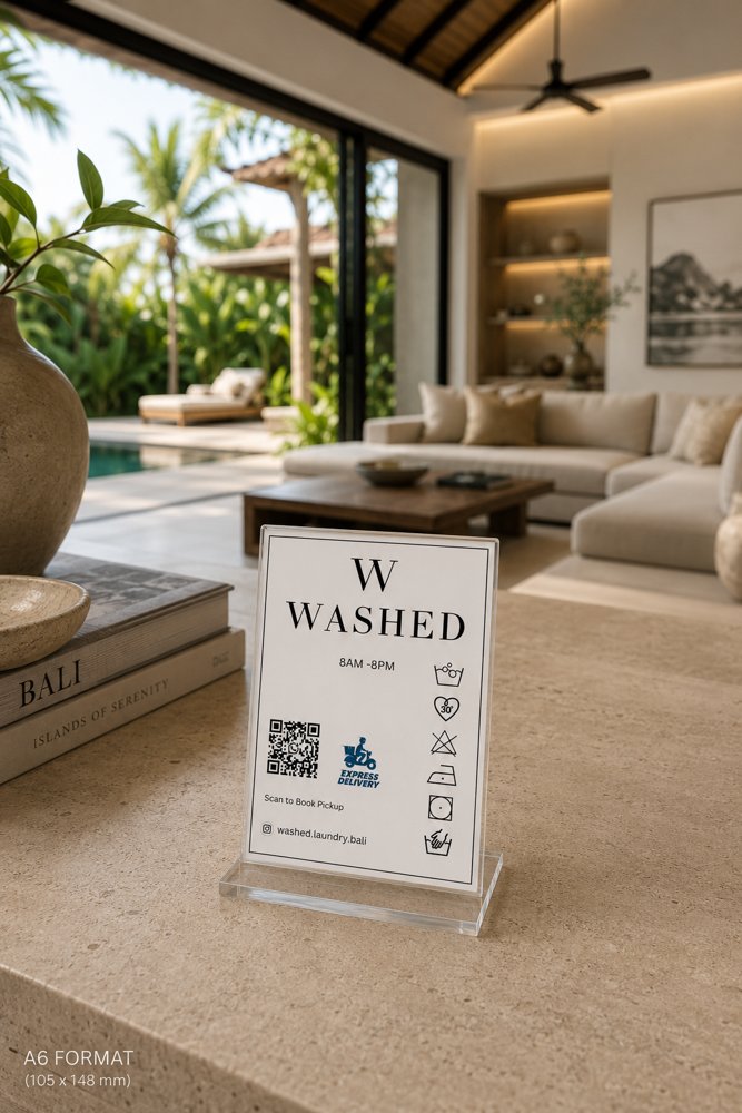 Washed in-room card with a QR code to book pickup, on a villa living-room table